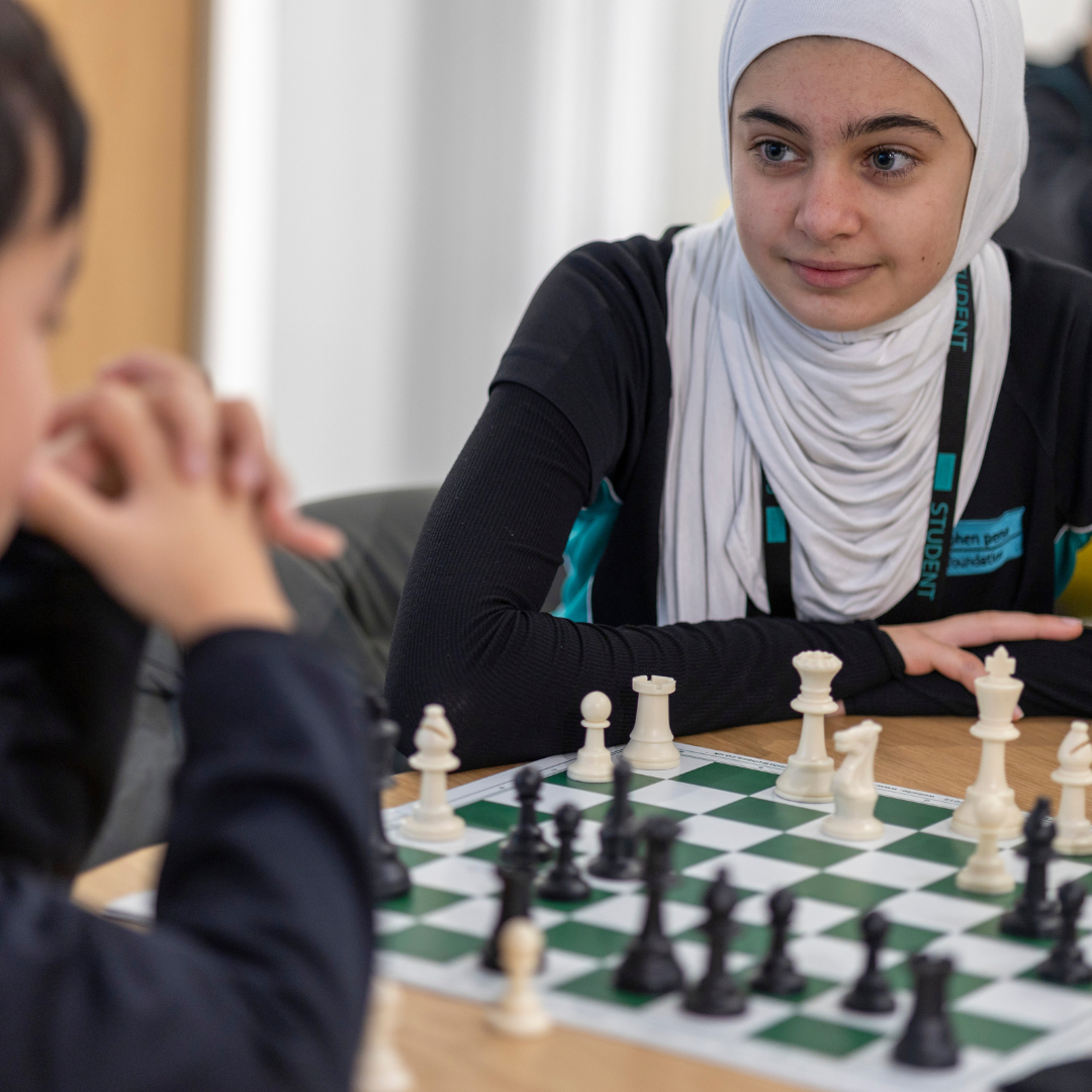 Students playing chess as part of the clubs and activities programme