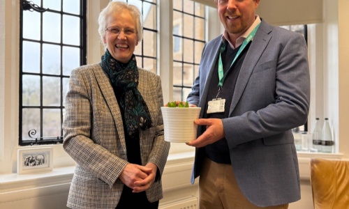 Katie Milne presenting a birthday hyacinth to Principal Richard Girvan to celebrate the 144th Birthday of Stephen Perse Cambridge